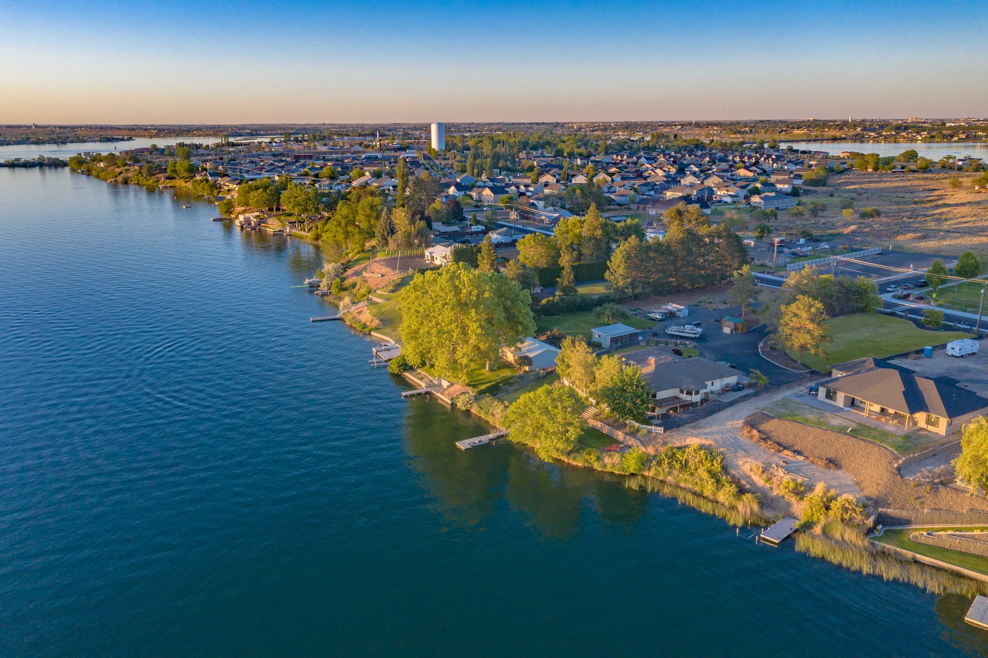 Aerial view of a waterfront neighborhood along the shoreline in Moses Lake, Central Washington, at golden hour