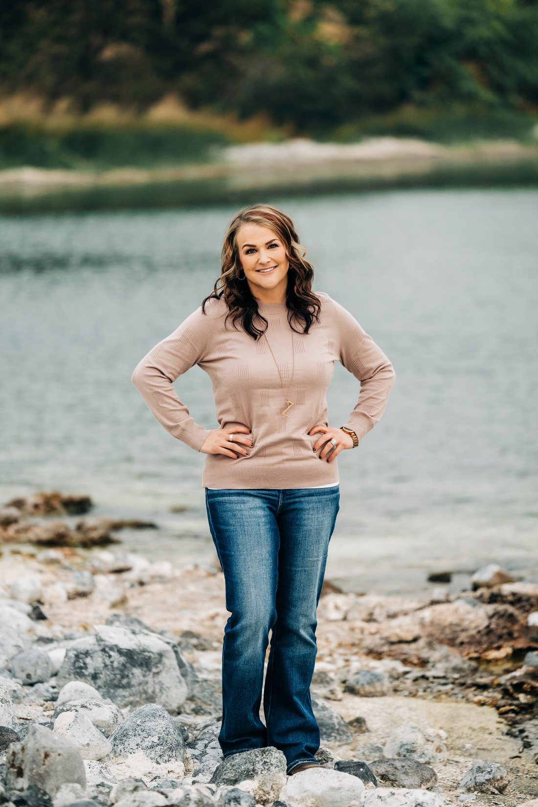 Tara Zerbo, Managing Broker with Better Homes and Gardens Real Estate Gary Mann Realty, standing along the water in Moses Lake, Washington